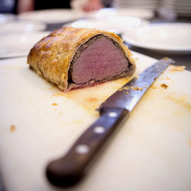 Great shot of a beef wellington ready to be served at a party catered by Beetham Food.