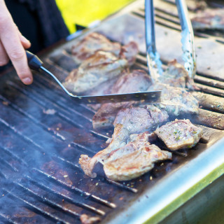 Photo of the team working a BBQ at an event catered by Beetham Food.