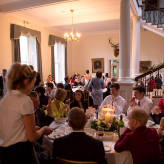 Photo of the waiting staff clearing plates and serving the guests at a wedding catered by Beetham Food.