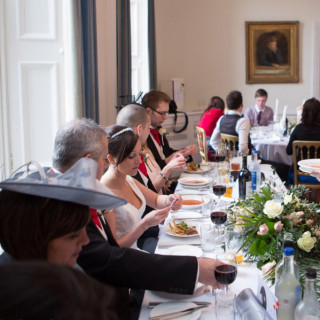 Photo of the bride, groom and their immediate family enjoying the food served by Beetham Food.