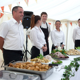 Photo of the team ready to serve at an event catered by Beetham Food.